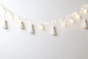 A string of lights with white paper trees hanging from it photo