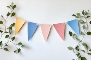 Colorful Pastel Bunting Flags with Greenery on White Background for Celebrations and Parties photo