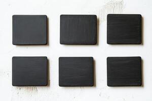 Minimalist Black Square Coasters on White Textured Background photo