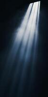 Rays of light piercing through a dark space, creating a mysterious and atmospheric ambiance. photo