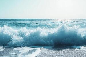 The ocean is calm and the waves are small. The sky is blue and the sun is shining photo