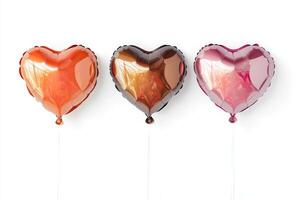 Three heart shaped balloons in vibrant colors against a white backdrop, ideal for parties and celebrations. photo