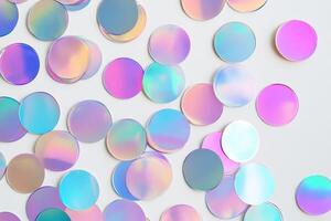Iridescent confetti circles scattered on a white surface, showcasing a vibrant and festive atmosphere perfect for celebrations. photo