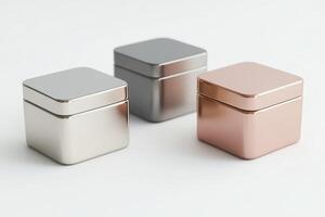 Three sleek metallic storage boxes in silver, gray, and rose gold, perfect for modern home decor and organization. photo