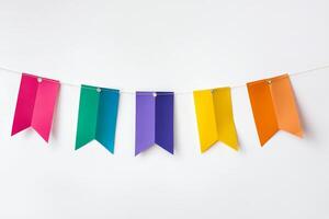 Vibrant paper banners in rainbow colors hanging on a string, perfect for celebrations and creative decor. photo
