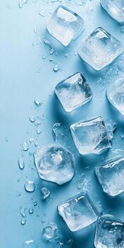 A blue background with ice cubes on it. The ice cubes are scattered all over the background. Some of them are closer to the top, while others are closer to the bottom photo