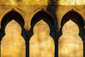 Three arches with shadows on the wall. The arches are yellow and the shadows are white photo