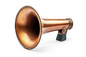 A large, old fashioned horned trumpet is sitting on a white background. The trumpet is made of brass and has a shiny, gold finish. Concept of nostalgia and history photo
