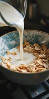 Fresh Milk Poured Over Crunchy Cereal in Decorative Bowl photo