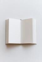 Open book with blank pages on a white background, perfect for design, art, and educational concepts. photo