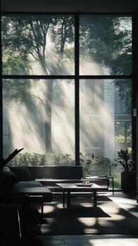 A living room with a large window that lets in sunlight photo