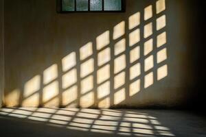 Sunlight Casting Geometric Shadows Through a Window onto a Rustic Wall in an Empty Room photo