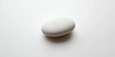 Minimalist White Stone on Smooth White Background photo