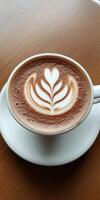 Elegant Latte Art in a White Cup on Wooden Table Capturing the Perfect Blend of Coffee photo