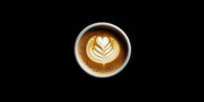 Creamy latte art with heart design in a round cup on dark background photo