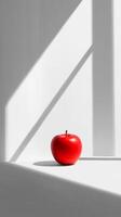 Bright Red Apple on Minimalist Background with Shadows and Light photo