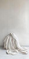 Minimalist Interior with Soft Beige Fabric Draped Against a Neutral Wall photo