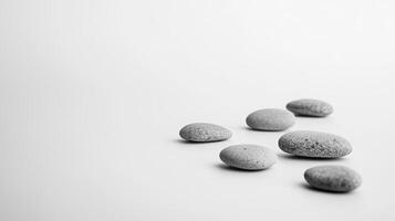 Minimalist Zen Stones on White Background for Tranquility and Balance in Modern Design Concepts photo
