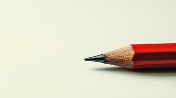 A red pencil with a black tip is on a white background photo