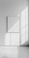 Minimalist Interior with Sunlit Empty Frame on White Wall in Bright Modern Room photo