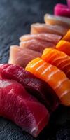 Fresh Assorted Slices of Sushi on Black Slate Serving Plate photo