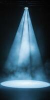 Soft Blue Spotlight Illuminating Stage Surface in Dark Setting photo