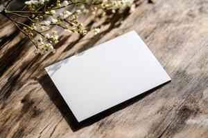 Blank Business Card Mockup on Rustic Wooden Surface with Flowers photo