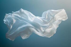 Elegant White Fabric Floating Gracefully Against a Soft Blue Background in Studio Lighting photo