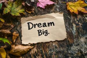 Inspirational Phrase on Paper Surrounded by Autumn Leaves photo