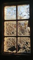 Sunlit Broken Window with Cracked Glass in an Abandoned Building Capturing Autumn Light and Shadows photo