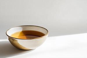 Elegant Ceramic Bowl of Tea on Minimalist White Background photo