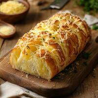 Freshly Baked Cheese Bread on Wooden Cutting Board with Herbs photo