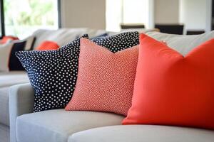 A couch with a red and black pillow on it photo