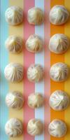 Steamed Dumplings Arranged on Colorful Stripes Background photo