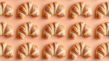 Freshly Baked Croissant Patterns on Soft Peach Background photo