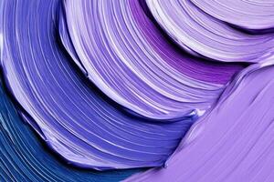 Close-up view of an artists palette showcasing vibrant lavender and deep blue paint swirls photo