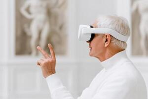 Elderly man experiences virtual reality in a digital museum setting using hand gestures for exploration photo
