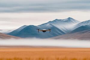 Drone flies over a beige desert landscape with gray-brown terrain and distant mountains under a cloudy sky photo