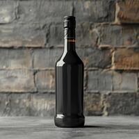 A black wine bottle with a black cap sits on a grey surface photo