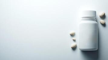 A simple arrangement featuring a white pill bottle and several loose tablets nearby photo