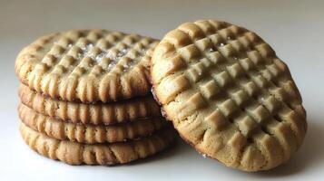Freshly baked peanut butter cookies stacked high, ready to enjoy with a cup of tea photo