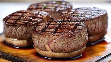 Grilled filet mignon steaks burst with rich flavors and textures on a wooden platter photo