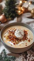 A bowl of potato soup with bacon and sour cream photo