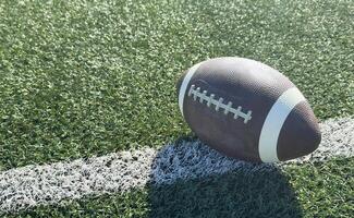 Pro American Football on the Field Close Up with Yard Lines Beyond photo