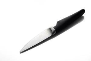 Sleek kitchen knife resting on white background with elegant shadows showcasing its design and craftsmanship photo