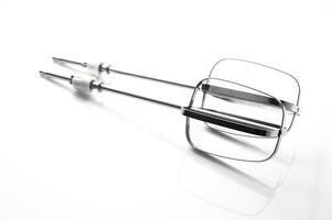 Whisks glimmering under bright light showcasing their sleek design and functionality for culinary adventures photo