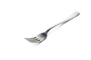 Unique silver fork with elongated tines resting on a plain white surface at midday photo