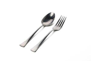 Elegant fork and spoon arranged on a white surface for a minimalist dining experience photo