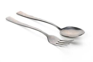 Sleek silver spoon and fork arranged elegantly on a minimalist white background photo