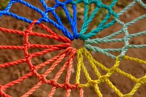 Colorful knots intertwine in a vibrant rope structure creating an artistic web of creativity photo